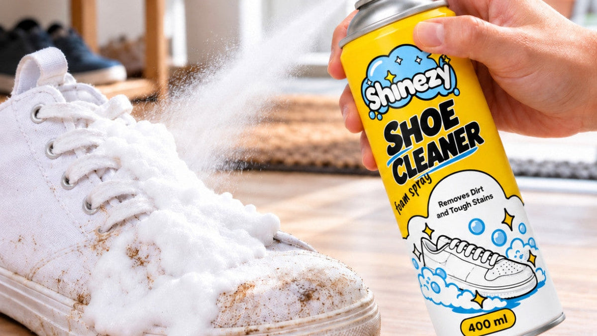 Spraying Shinezy Shoe Cleaner foam onto a dirty white canvas sneaker