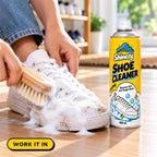 Working Shinezy Shoe Cleaner foam into a sneaker with a soft brush