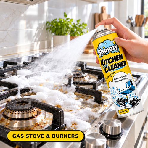 Shinezy Kitchen Cleaner foam sprayed on a gas stove and burners
