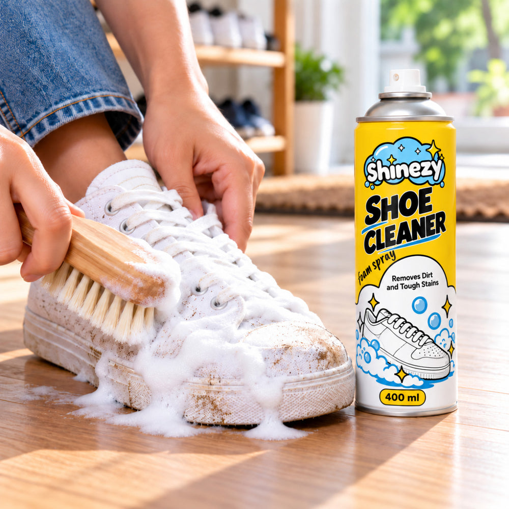 Working Shinezy Shoe Cleaner foam into a white canvas sneaker with a soft brush